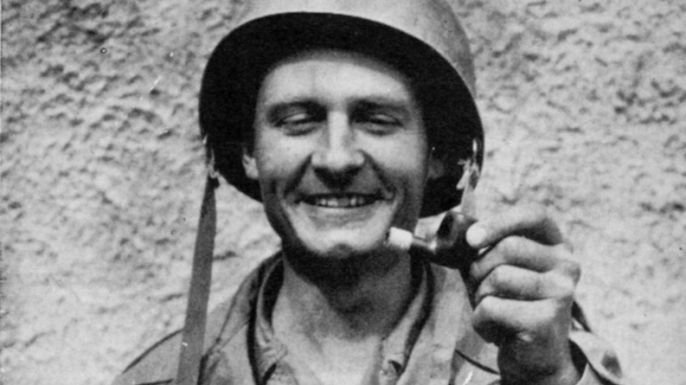 Emil Kapaun holding a broken tobacco pipe that had been shot out of his mouth by a sniper as he crawled forward in battle to drag American GIs to safety. (Credit: The Wichita Diocese)