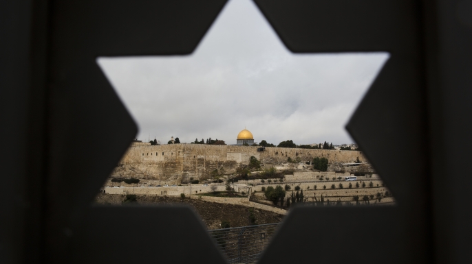 Jerusalem seen through a door with the shape of the star of David. U.S. officials say President Donald Trump will recognize Jerusalem as Israel's capital Wednesday, Dec. 6, and instruct the State Department to begin the multi-year process of moving the American embassy from Tel Aviv to the holy city. (Credit: Oded Balilty/AP Photo)
