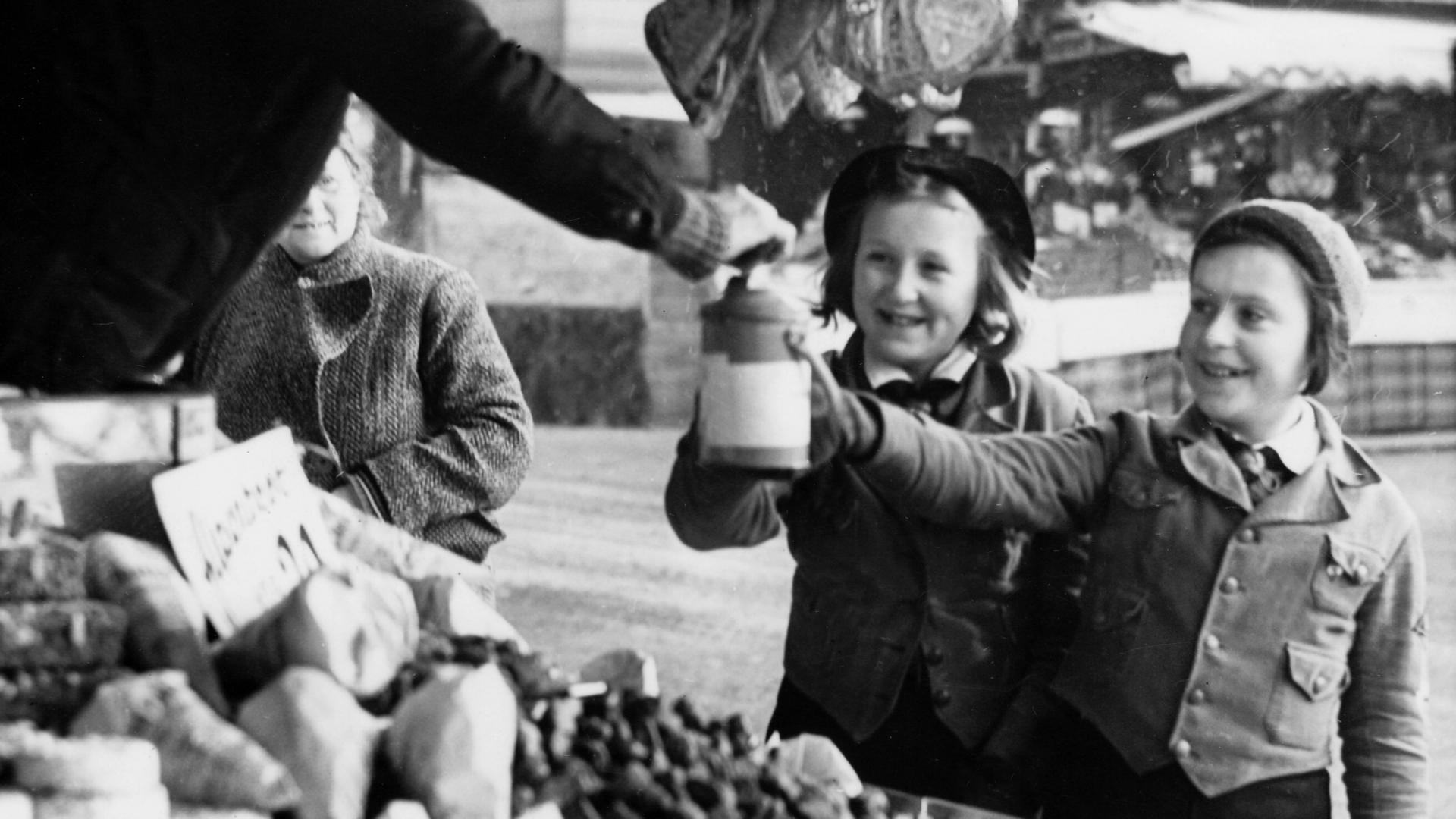 Girls of the German Girls League collecting donations for the Winter Relief of the German people, at a Christmas market, in December 1938. (Credit: Berliner Verlag/Archiv/picture-alliance/dpa/AP Images)
