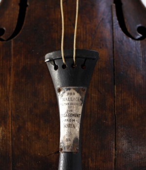 The violin owned and played by bandmaster Wallace Hartley during the final moments before the sinking of the Titanic, displayed at a conservation studio in Lurgan, Northern Ireland, 2013. The violin was recovered along with his body 10 days after he and other band members played to calm passengers on the deck of the stricken ship after it hit an iceberg on its maiden voyage. The instrument bears an engraved message from the musician's fiance that reads: For Wallace, on the occasion of our engagement. From Maria. (Credit: Peter Muhly/AFP/Getty Images)