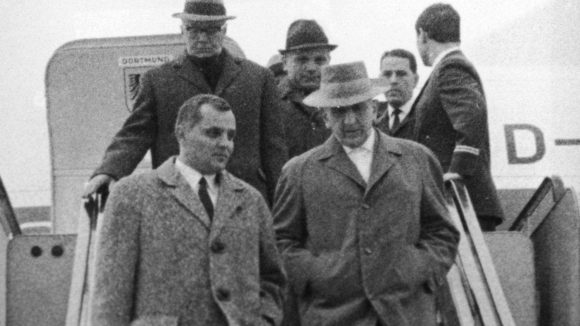 Gerhard Bohne (right) arriving at Frankfurt Airport from Buenos Aires, accompanied by two officials of the district criminal board of Wiesbaden. Bohne would be prosecuted for administering the Nazi's euthanasia program aimed at purifying the Aryan race of people with physical infirmities and mental disabilities. (Credit: Keystone/Getty Images)