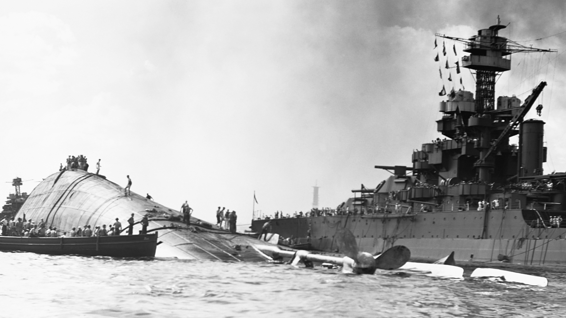 The USS Oklahoma floating capsized near the USS Maryland. (Credit: Corbis via Getty Images)