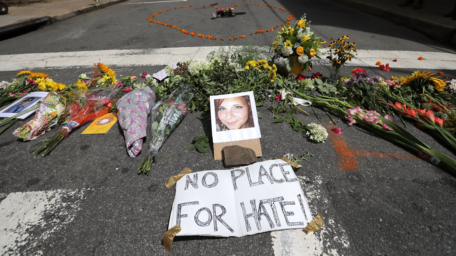 Flowers surrounding a photo of 32-year-old Heather Heyer, who was killed when a car plowed into a crowd of people protesting against the white supremacist Unite the Right rally, August 13, 2017 in Charlottesville, Virginia. (Credit: Chip Somodevilla/Getty Images)