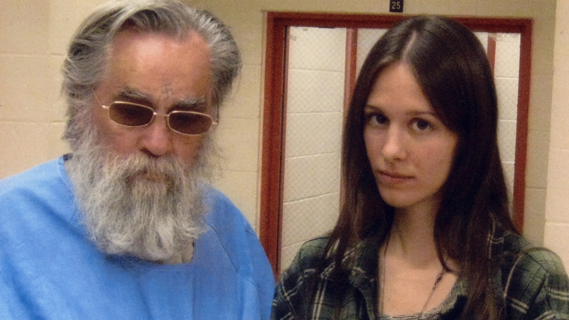 Charles Manson and the 25-year-old 'fan' he named Star who started by visiting him every Saturday and Sunday before they got engaged. She moved near the Corcoran State Prison when she was 19, to be closer to him and carved an X into her forehead, as many Manson followers have done over the years. (Credit: Polaris Images)