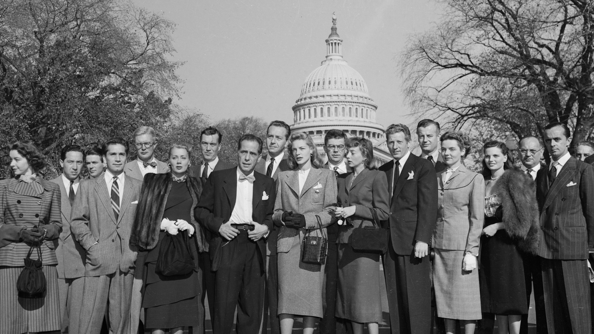 A group of Hollywood celebrities at the Capitol to protest the tactics of the House Un-American Activities Committee's investigation into alleged Hollywood communism. This photo includes actors like Humphrey Bogart and Lauren Bacall. (Credit: Bettmann Archive/Getty Images)