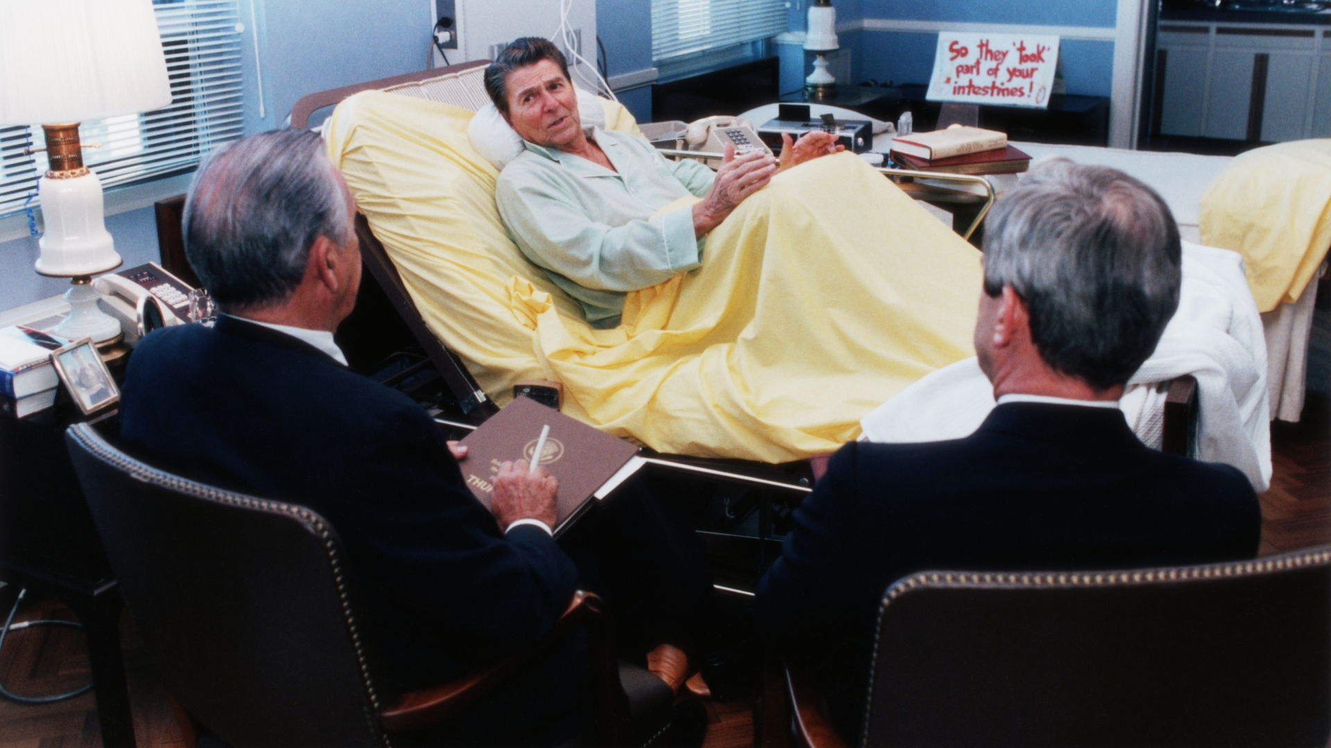 President Ronald Reagan holding a meeting with advisers while in the hospital for colon cancer surgery, 1985. (Credit: Corbis via Getty Images)