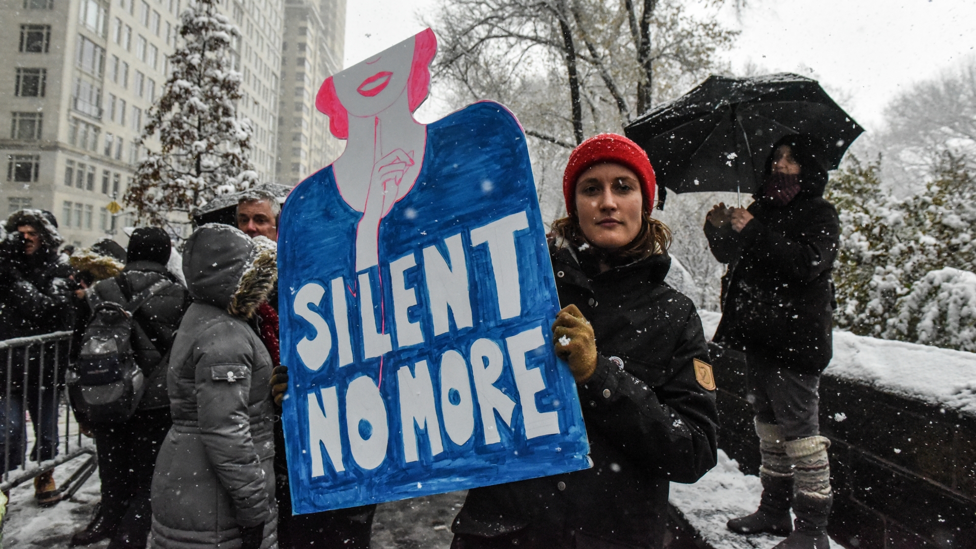 People carry signs addressing the issue of sexual harassment at a #MeToo rally in New York City, December 9, 2017. (Credit: Stephanie Keith/Getty Images)