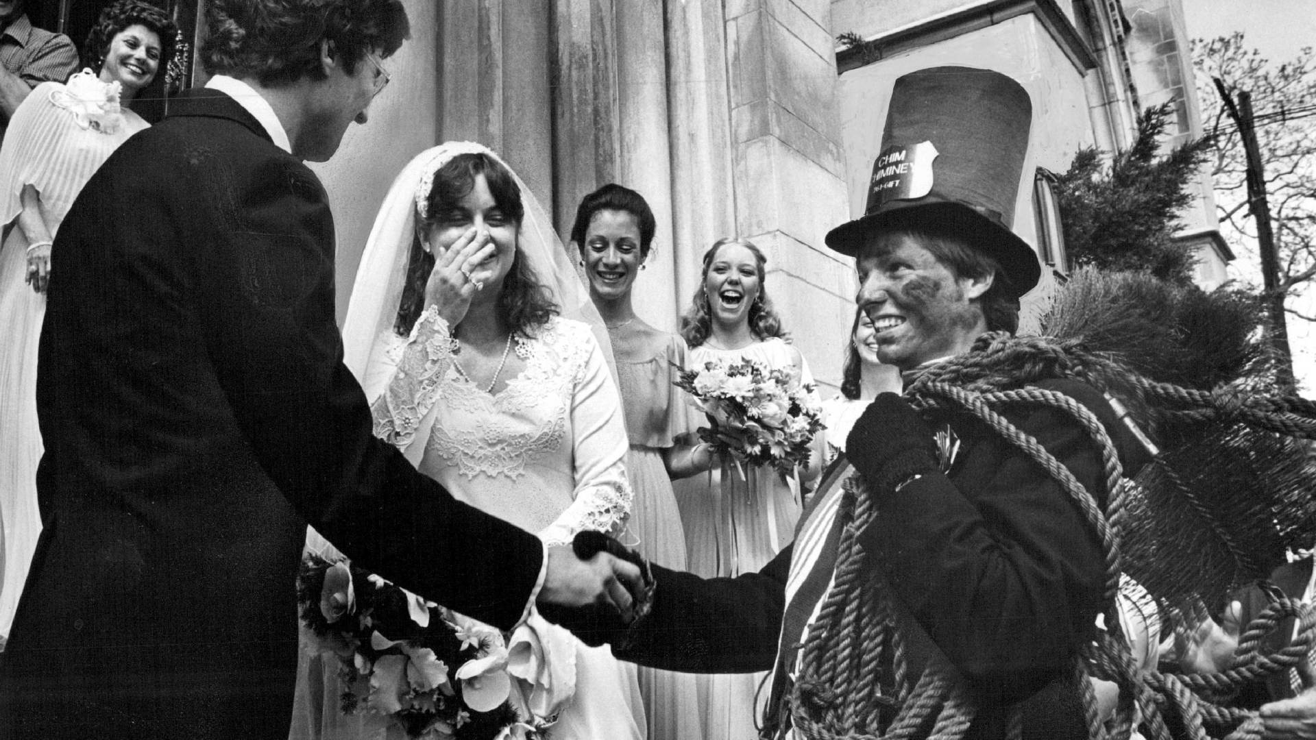 Newlyweds keeping alive a centuries-old tradition of having a chimney sweep wait outside a church and shake hands with wishes of good luck. (Credit: Ernie Leyba/The Denver Post via Getty Images)