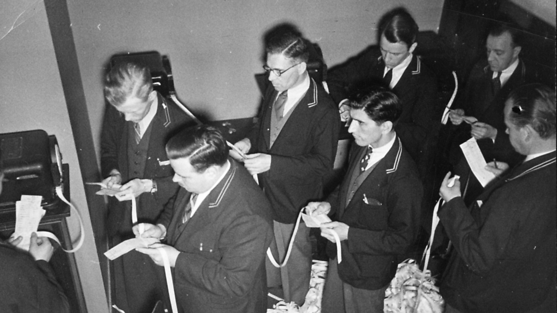 Ffloor traders checking the stock prices on ticker tape at the New York Stock Exchange, taken in New York City, 1938. (Credit: University of New Hampshire/Gado/Getty Images)