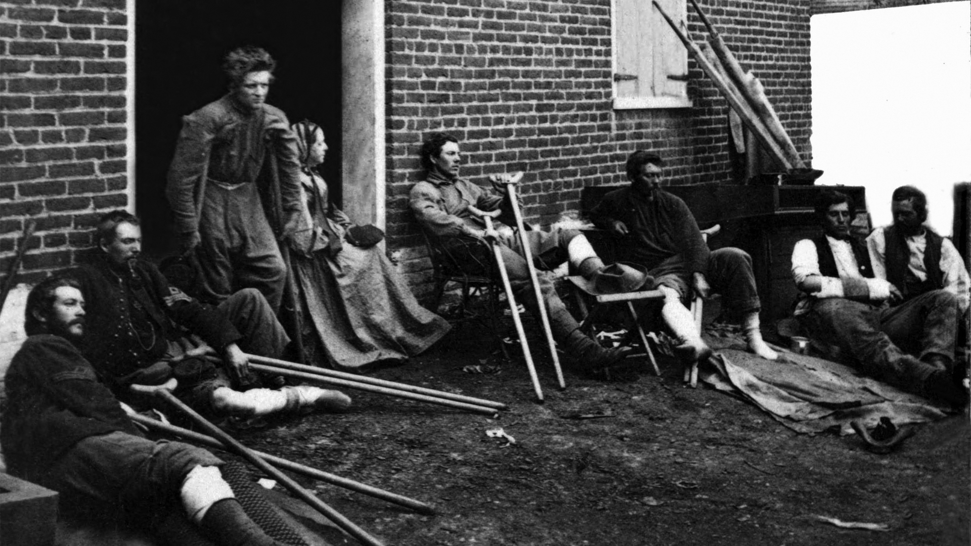 Wounded soldiers outside a brick hospital building in Fredericksburg, Virginia, 1864. (Credit: James Gardner/Buyenlarge/Getty Images)