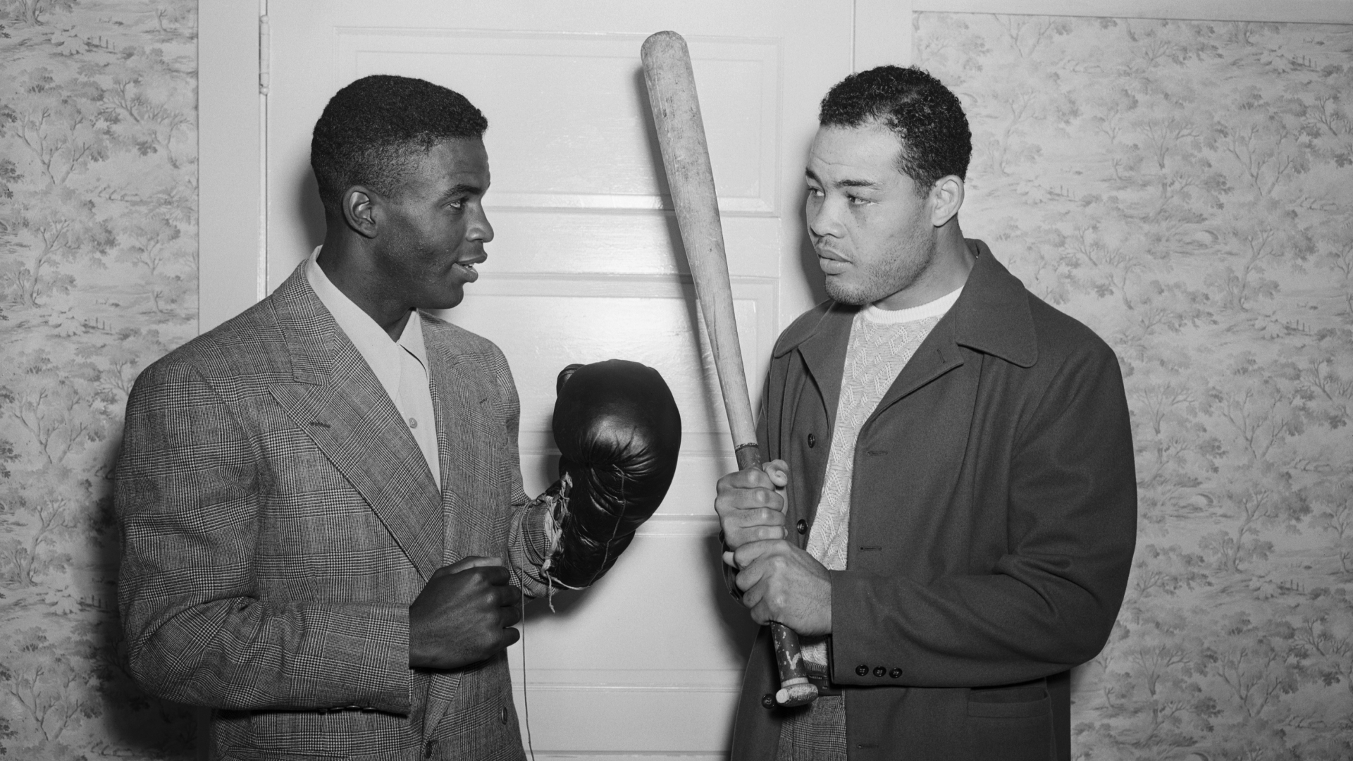 Jackie Robinson with heavyweight champion Joe Louis at Louis' Pompton Lake, NJ, training camp, 1946. (Credit: Bettmann Archive/Getty Images)