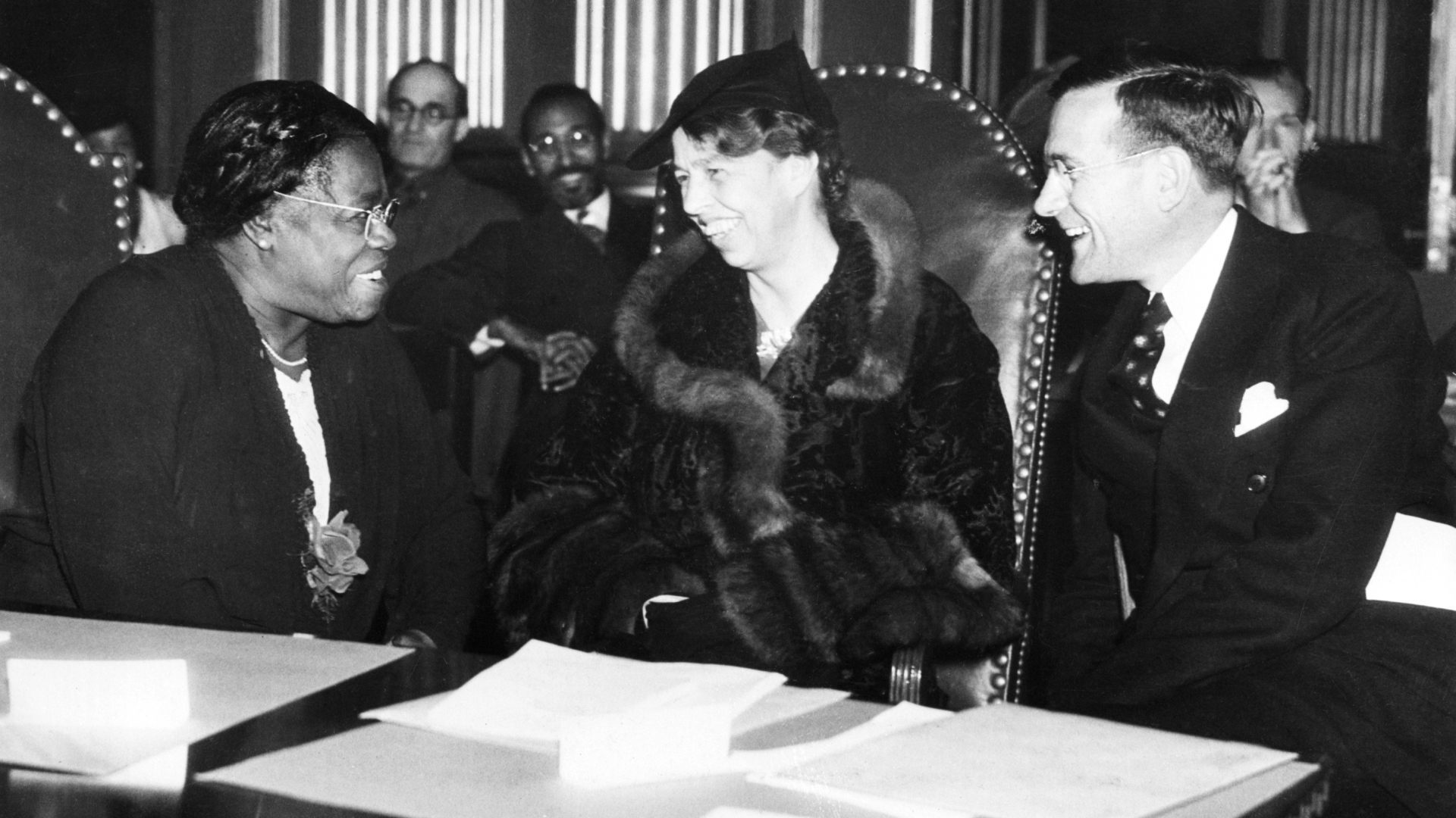 Mary McLeod Bethune , NYA Director of Negro Activities, speaking with First Lady Eleanor Roosevelt with Aubrey Williams, Executive Director of the National Youth Administration, at the opening session of the National Conference on Problems of the Negro and Negro Youth, 1937. (Credit: Bettmann Archive/Getty Images)