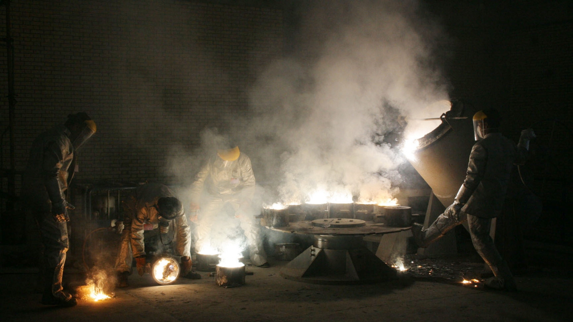 Men work inside of the Isfahan Uranium Conversion Facilities, outside of Tehran, Iran, 2005. They opened their doors for pictures to show its good intentions amid mounting international pressure for a halt to its controversial nuclear program. (Credit: Getty Images)